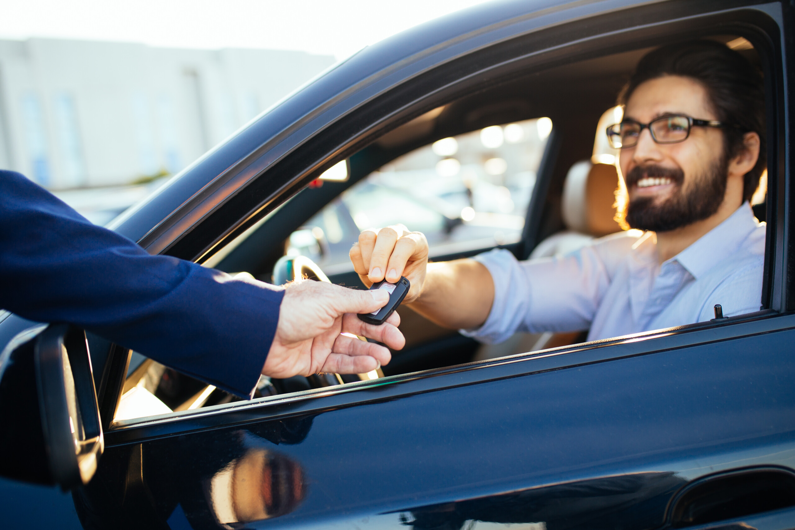 Happy customer receiving keys to rental car